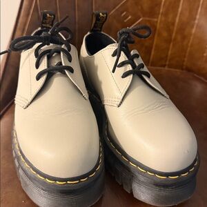 Dr. Martens ran Leather Shoes with Black Laces.